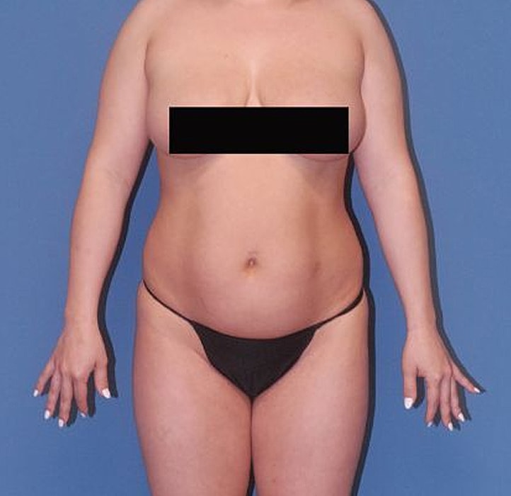 Model posing in underwear against a blue background.