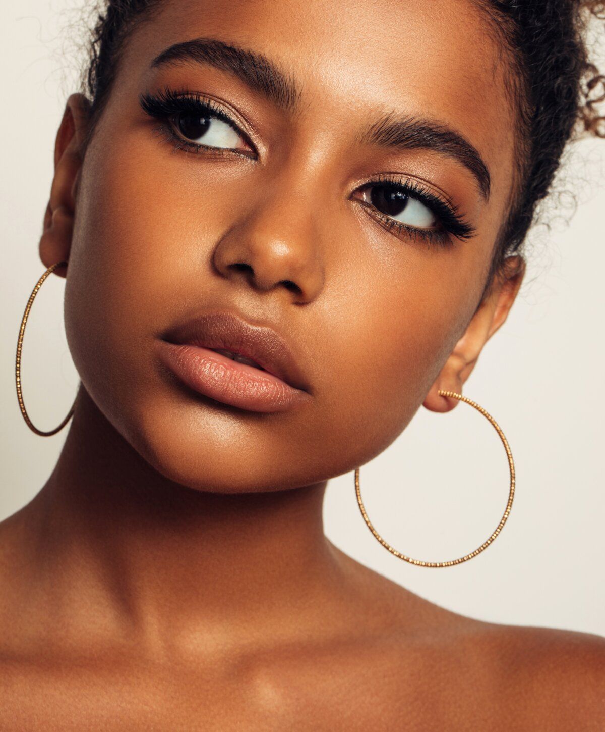Close-up of a woman with hoop earrings.