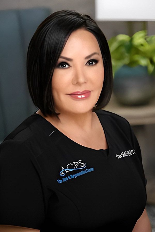 Female professional in medical scrubs portrait.