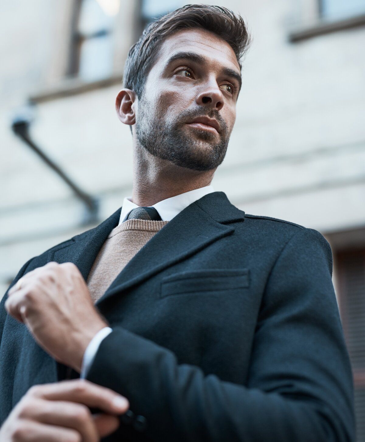 PRF hair restoration model posing in stylish casual outfit against wall.