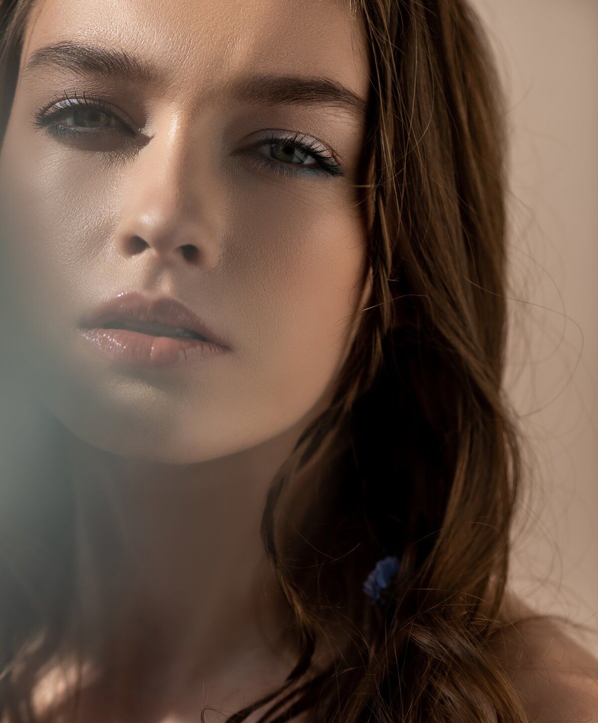 Close-up portrait of a woman with wavy hair.