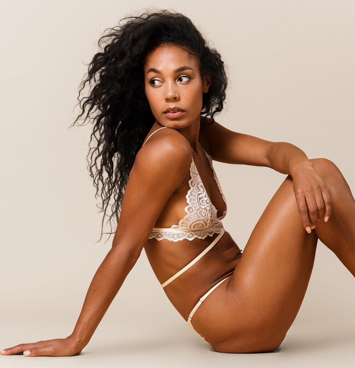 Model in delicate lingerie posing gracefully.