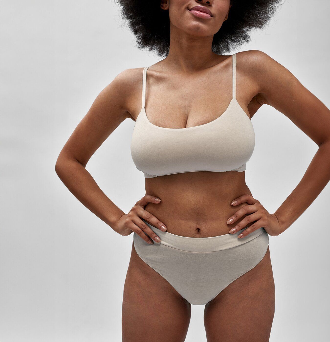 Model wearing a beige bra and underwear set.