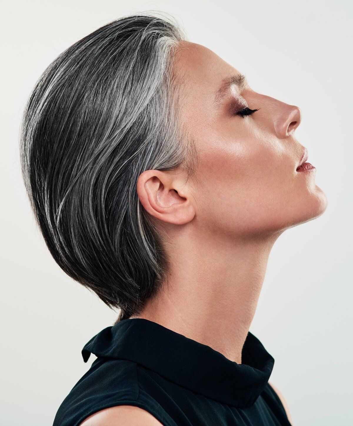 Profile of a woman with sleek gray hair