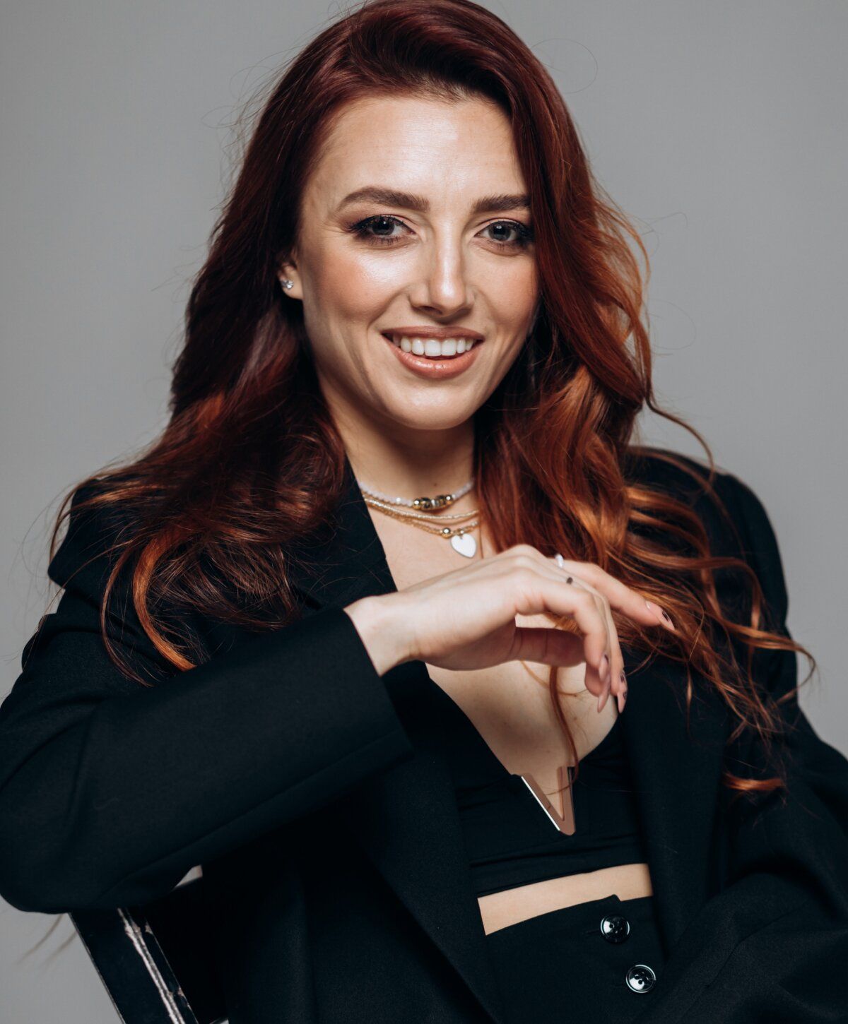 Smiling woman in stylish black outfit, portrait.