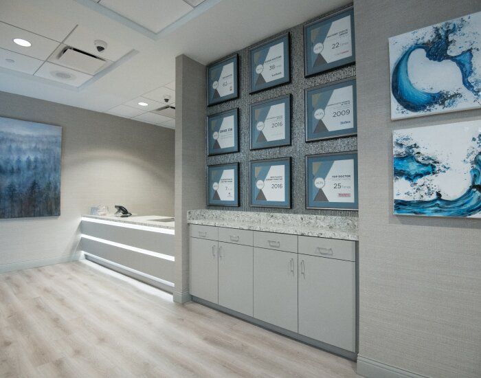Modern office interior with framed awards and art.