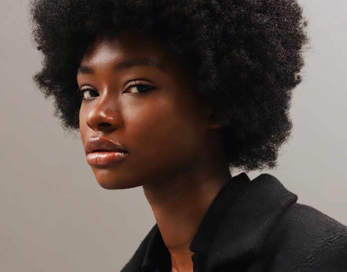 Portrait of a woman with natural curly hair.