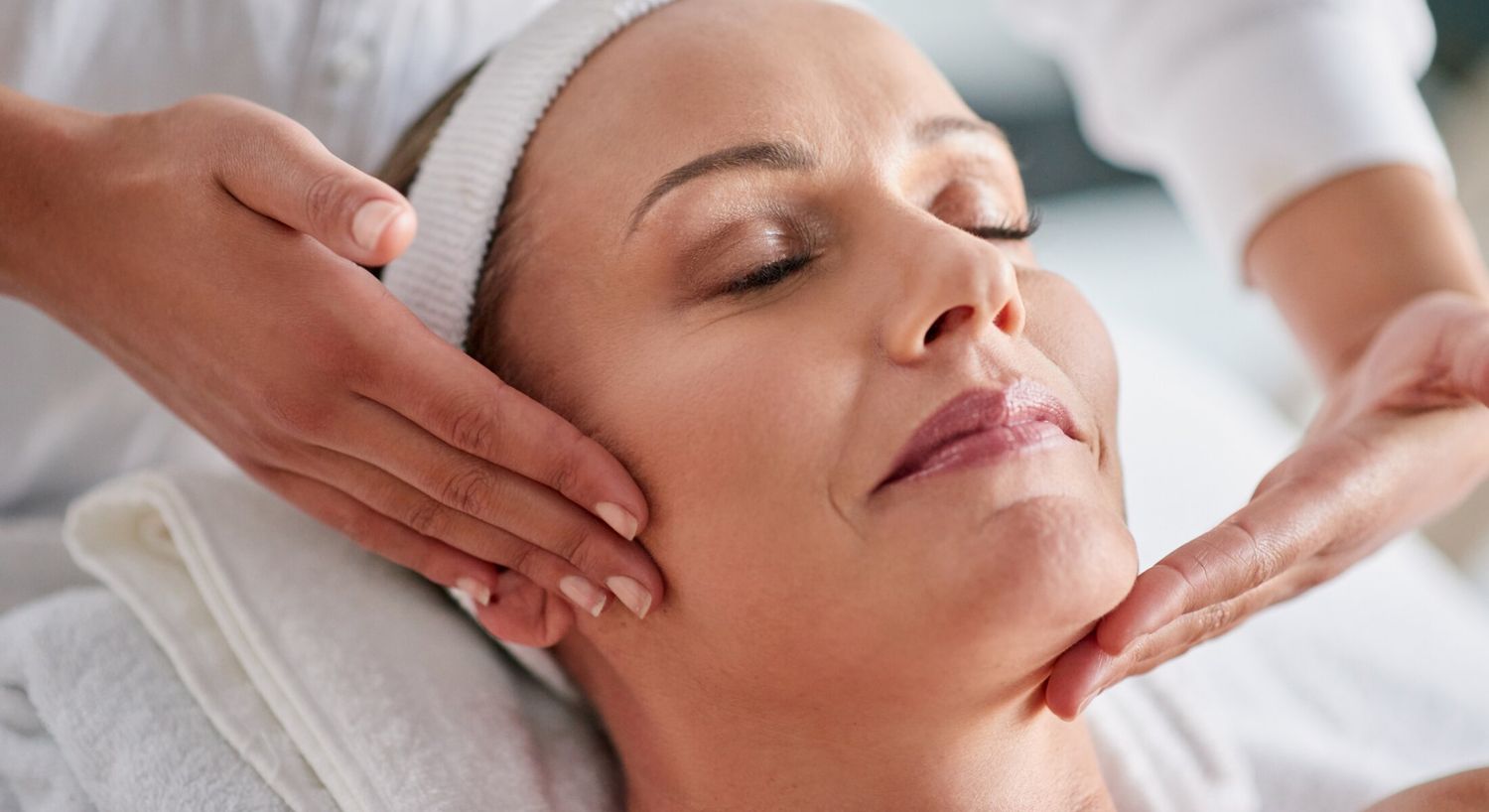 Facial massage in a spa setting.