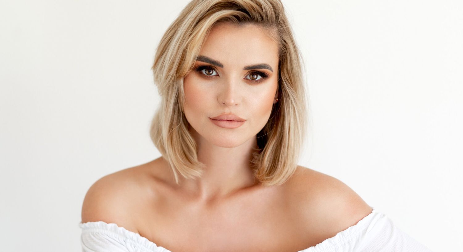 Woman with blonde hair and natural makeup.